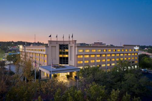 a large white building with a lit up building at Delta Hotels by Marriott Little Rock West in Little Rock