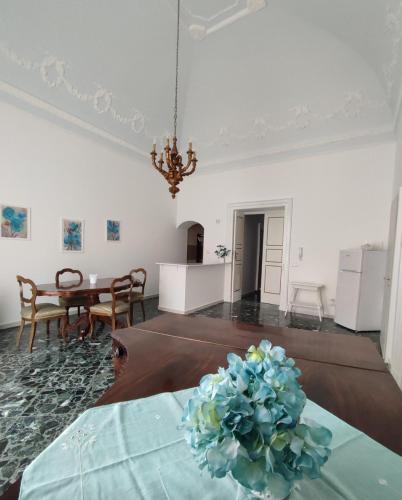 a living room with a table with a plant on it at Dimora della Marchesa - al Duomo in Manfredonia