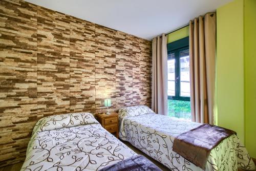 Кровать или кровати в номере Apartamentos Barajas