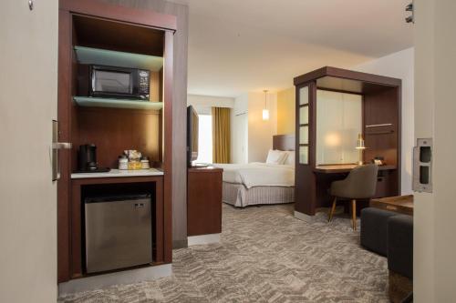 a hotel room with a bed and a living room at SpringHill Suites Quakertown Pennsylvania in Quakertown
