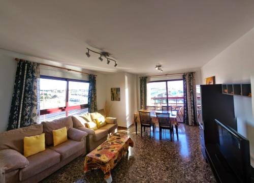 a living room with a couch and a table at Apartamentos Milenio in Cullera