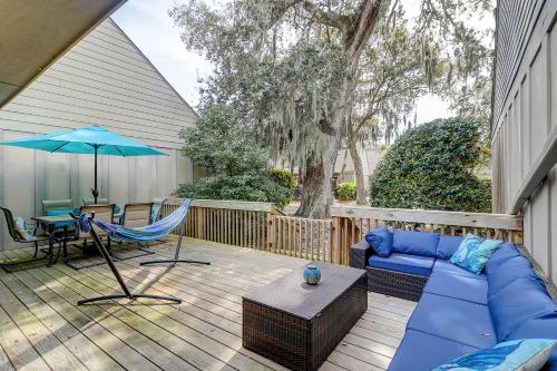 een patio met een bank, een tafel en een parasol bij Queens Grant in Hilton Head Island