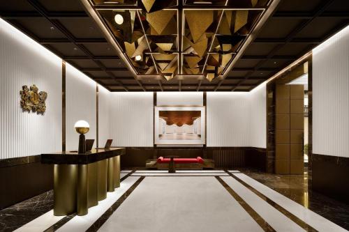 a lobby with a red bench in the middle of a room at Josun Palace, a Luxury Collection Hotel, Seoul Gangnam in Seoul