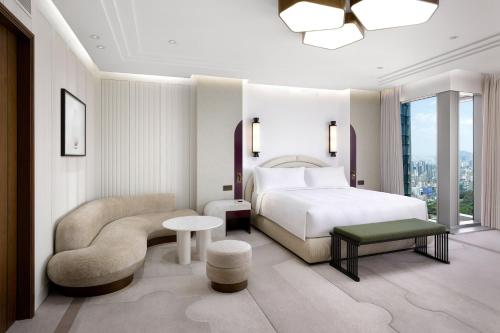 a hotel room with a bed and a chair at Josun Palace, a Luxury Collection Hotel, Seoul Gangnam in Seoul