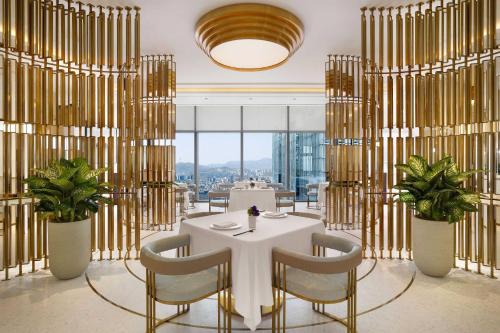 a dining room with a white table and chairs at Josun Palace, a Luxury Collection Hotel, Seoul Gangnam in Seoul