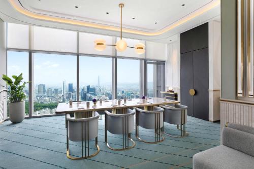 a dining room with a table and chairs and large windows at Josun Palace, a Luxury Collection Hotel, Seoul Gangnam in Seoul