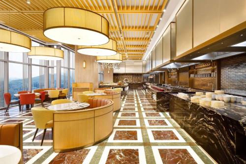 a restaurant with a lobby with tables and chairs at Josun Palace, a Luxury Collection Hotel, Seoul Gangnam in Seoul