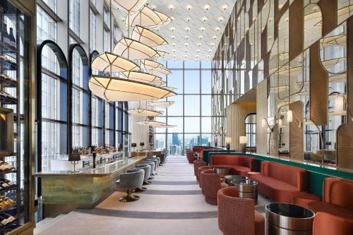 a view of a restaurant with red chairs and windows at Josun Palace, a Luxury Collection Hotel, Seoul Gangnam in Seoul