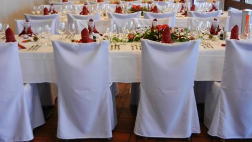 a table with white chairs and a white table with roses at Hotel La Campagnola - Green Energy Resort in San Nazzaro