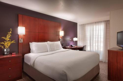 a bedroom with a large bed and a television at Residence Inn Salt Lake City Sandy in Sandy