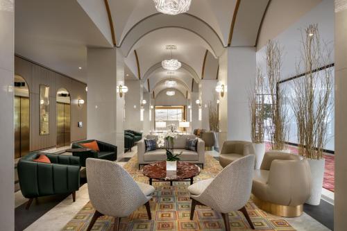 a lobby with couches and a table and chairs at Montreal Marriott Chateau Champlain in Montréal