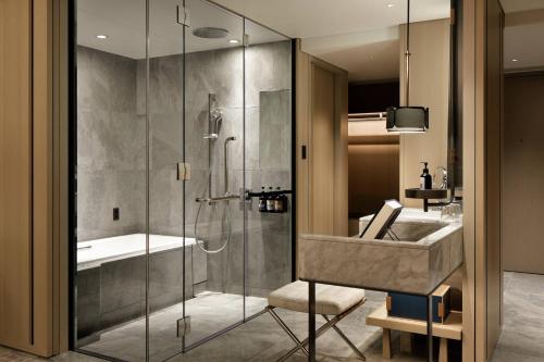 a bathroom with a shower and a sink at mesm Tokyo, Autograph Collection in Tokyo