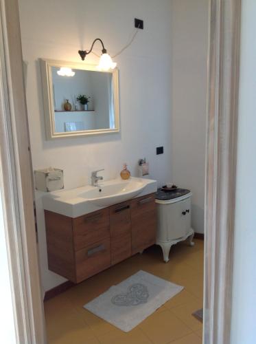 a bathroom with a sink and a mirror and a toilet at B&B Lacrêma in Finale Ligure