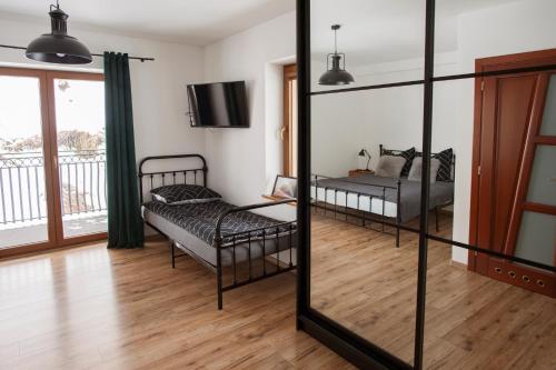 a bedroom with two beds and a mirror at KANIA Apartamenty - Zakopane in Zakopane