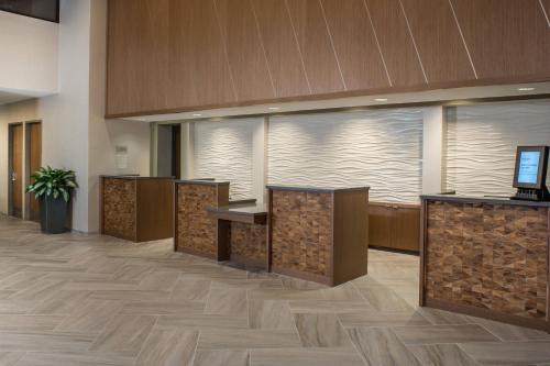 an office lobby with wooden reception desks and a large window at Marriott Tampa Westshore in Tampa