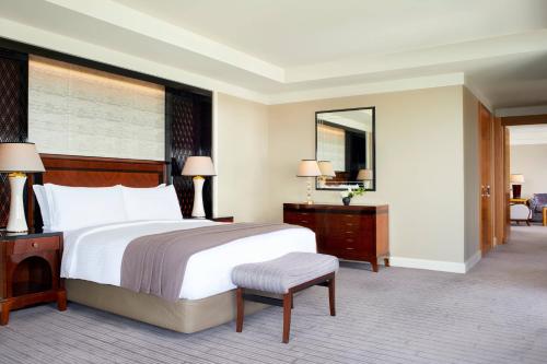 a bedroom with a large bed and a large mirror at The Ritz-Carlton, Tokyo in Tokyo