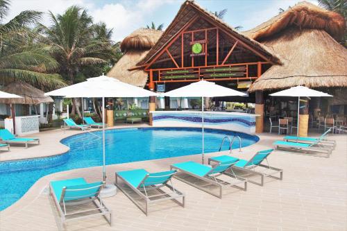 a resort with a pool with chairs and umbrellas at Margaritaville Island Reserve Riviera Cancún - A Karisma All-Inclusive Experience for All in Puerto Morelos