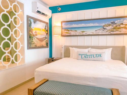 a bedroom with a bed and a painting on the wall at Margaritaville Island Reserve Riviera Cancún - A Karisma All-Inclusive Experience for All in Puerto Morelos