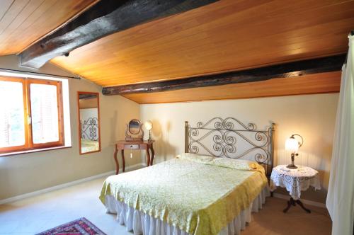 a bedroom with a bed and a wooden ceiling at Coliberto in Massa Marittima