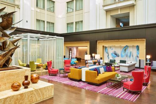 a lobby with colorful chairs and couches in a building at The Nines, a Luxury Collection Hotel, Portland in Portland