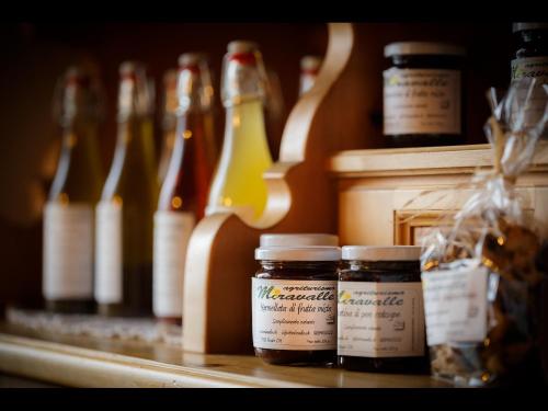 a row of bottles of honey on a counter with bottles of beer at Agriturismo Miravalle in Brusio