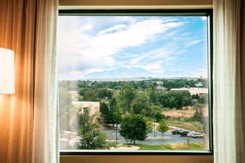 a view of mountains from a window in a hotel room at Denver Marriott Westminster in Westminster