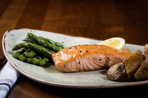 a plate of food with a piece of fish and vegetables at Denver Marriott Westminster in Westminster