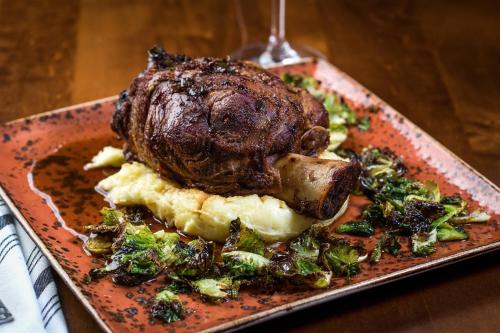 a plate of food with a piece of meat and broccoli at Denver Marriott Westminster in Westminster