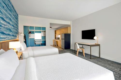 a hotel room with two beds and a desk at TownePlace Suites by Marriott Asheville West in Asheville