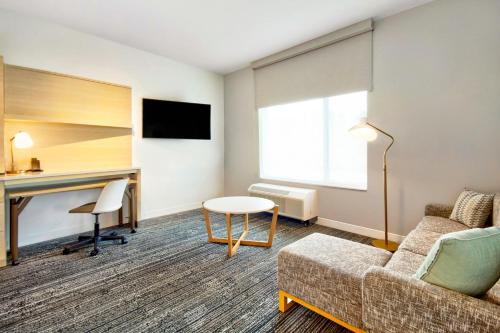 a living room with a couch and a desk at TownePlace Suites by Marriott Asheville West in Asheville
