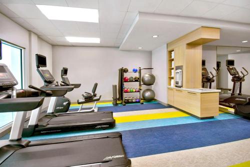 a gym with a treadmill and ellipticals in a room at TownePlace Suites by Marriott Asheville West in Asheville