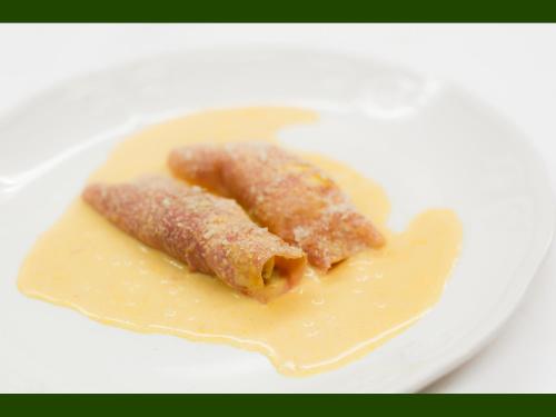 a piece of food on a plate with sauce at Agriturismo Miravalle in Brusio