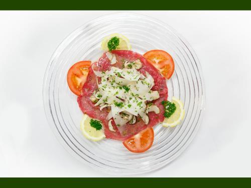 a plate of food with tomatoes and cheese on it at Agriturismo Miravalle in Brusio