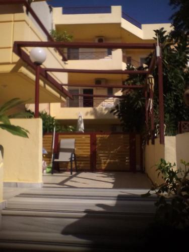 a building with a garage in front of it at Leonidas Rooms in Plataniás