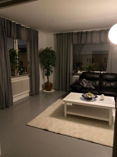 a living room with a couch and a coffee table at Lektorn in Nässjö