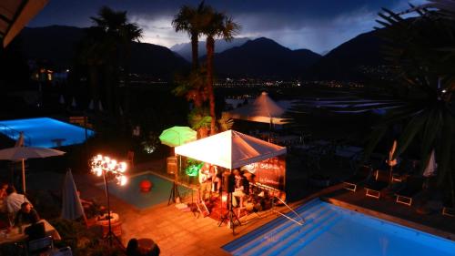 a view of a pool at a resort at night at Hotel La Campagnola - Green Energy Resort in San Nazzaro