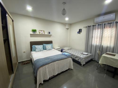 a hospital room with two beds and a table at Apartamento RR Agradable y Moderno c 2 dormitorios y estacionamiento interno techado in Ciudad del Este