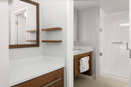 a bathroom with a sink and a mirror at Residence Inn by Marriott Tuscaloosa in Tuscaloosa