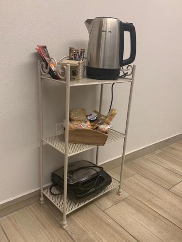 a shelf with a tea kettle on top of it at Garda Lake Maison d'Isabella in Lonato del Garda