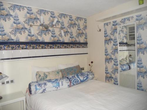 a bedroom with blue and white wallpaper and a bed at Apartamento loft en Costa Vasca Mutriku a 7 minutos de playa Casa Azul in Mutriku