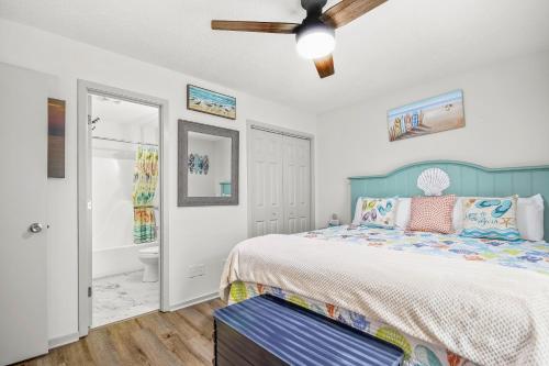 a bedroom with a bed and a ceiling fan at Lil River Paradise in Little River