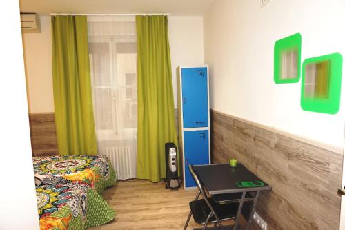 a room with a bed and a table in a room at Mucho Madrid in Madrid