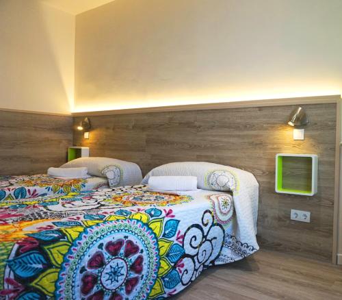 two beds in a hotel room with at Mucho Madrid in Madrid