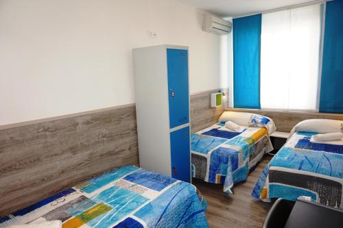 a room with two beds and a window at Mucho Madrid in Madrid