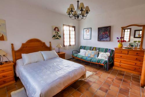 a bedroom with a large bed and a couch at CASA LAXE in Miñortos