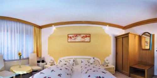 a bedroom with a large white bed in a room at Hotel Garden in Bautzen