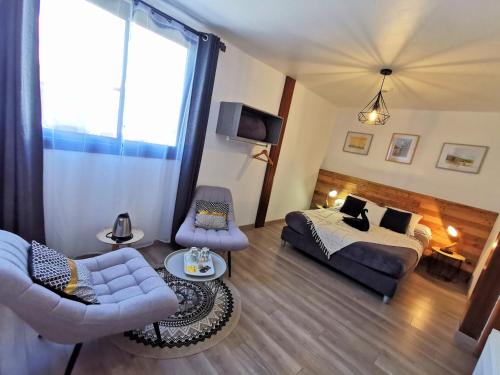 a living room with a bed and a couch at Côté Volcan in La Plaine des Cafres