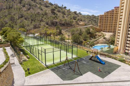 an image of a tennis court in a park at Renthas Torre Lugano in Benidorm