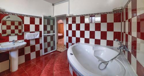 a bathroom with a bath tub and a sink at Home for travellers. in Port Louis