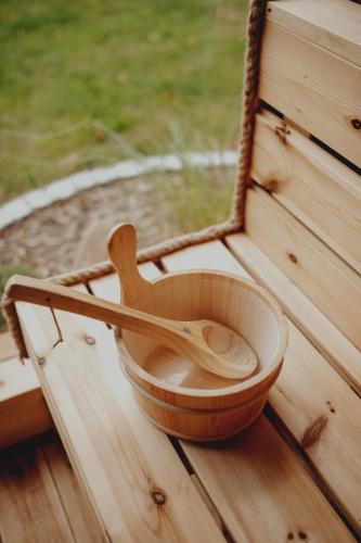 a wooden bowl with a wooden spoon sitting on a table at Pasieka Podlaska Tradycja in Siemiatycze